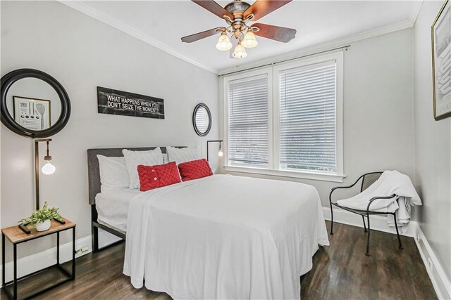 bedroom featuring baseboards, wood finished floors, and crown molding