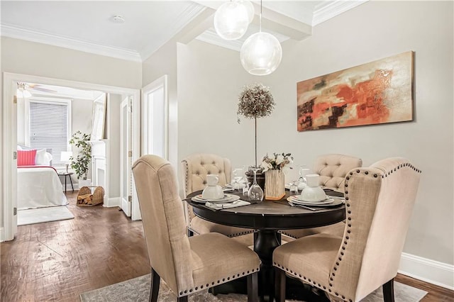 dining room with wood finished floors, baseboards, and ornamental molding