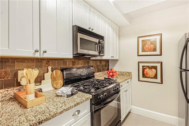 kitchen featuring white cabinetry, baseboards, and stainless steel appliances