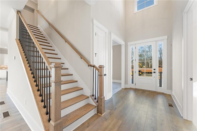 entryway with a high ceiling and light wood-type flooring