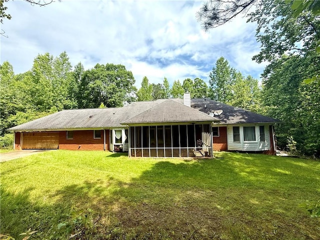 8872 Conners Rd, Villa Rica, GA 30180 - back of property with a chimney, a sunroom, a lawn, and driveway