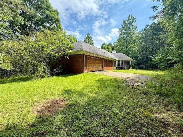 8872 Conners Rd, Villa Rica, GA 30180 - view of grassy yard with a garage, driveway, and a sunroom