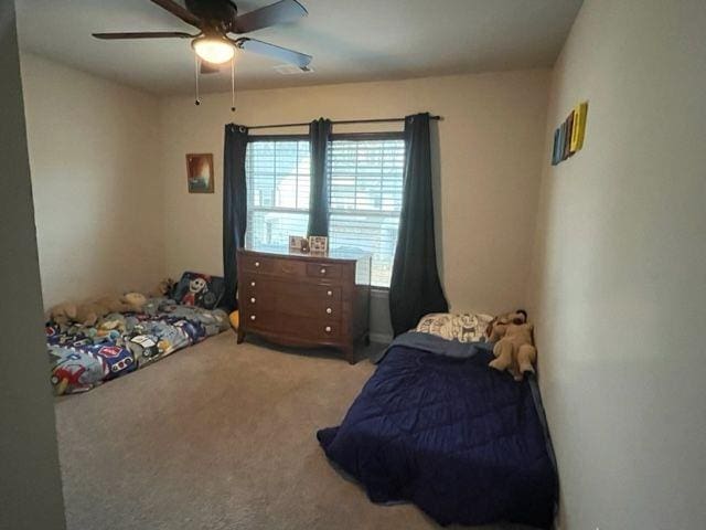 carpeted bedroom featuring ceiling fan