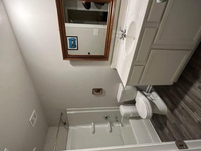 bathroom with wood-type flooring and toilet