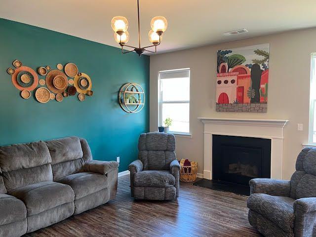 living room featuring dark hardwood / wood-style floors and a notable chandelier