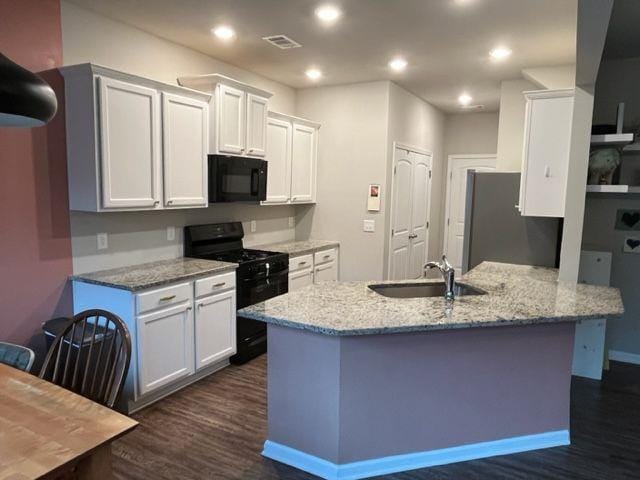 kitchen featuring white cabinets, light stone countertops, sink, and black appliances