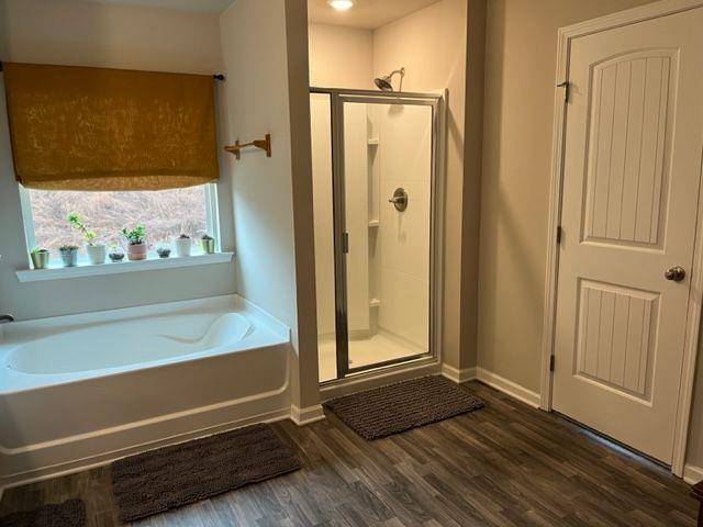 bathroom featuring hardwood / wood-style flooring and separate shower and tub