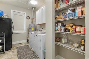 washroom with separate washer and dryer and cabinets