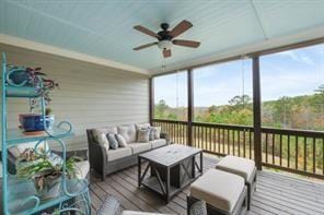 sunroom / solarium featuring a wealth of natural light and ceiling fan