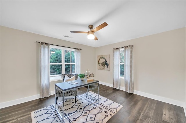 home office with dark hardwood / wood-style flooring, ceiling fan, and plenty of natural light