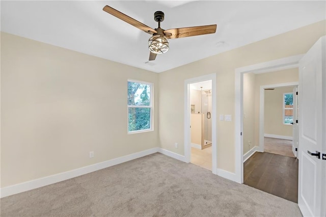 unfurnished bedroom featuring light carpet and ceiling fan