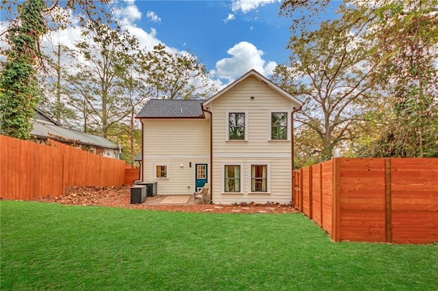 rear view of house with a yard and a patio