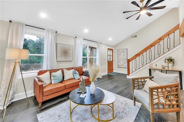 living room featuring dark hardwood / wood-style flooring, ceiling fan, plenty of natural light, and vaulted ceiling