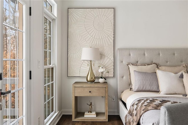 bedroom with baseboards and wood finished floors