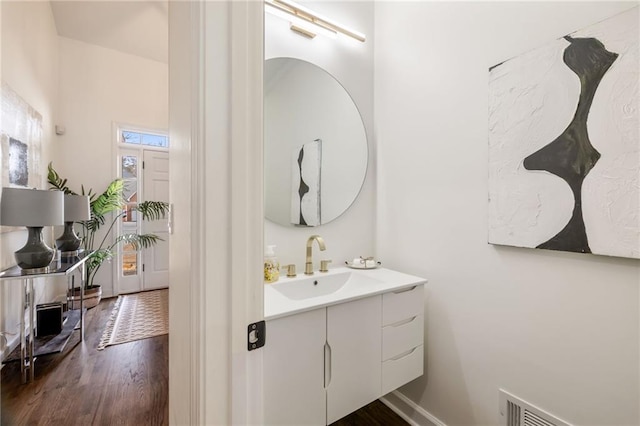 bathroom featuring visible vents, vanity, and wood finished floors