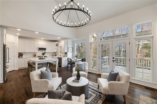 living room with recessed lighting, high vaulted ceiling, dark wood-type flooring, and french doors