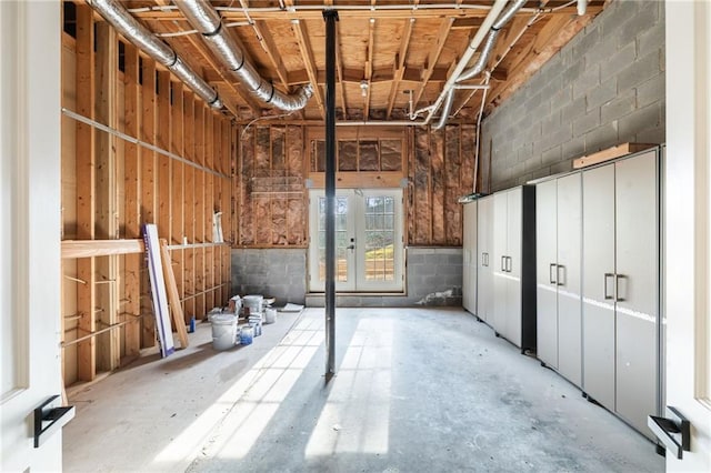 miscellaneous room featuring concrete block wall and concrete floors