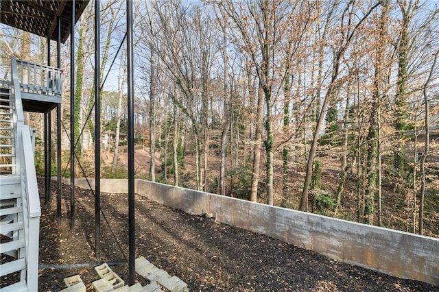 view of yard with stairway and a wooden deck