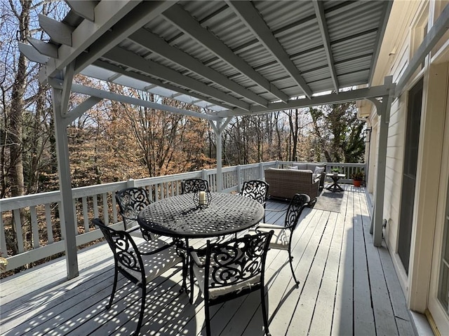 wooden terrace featuring outdoor dining area and an outdoor living space