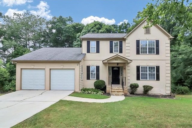 view of front of property featuring a garage and a front lawn