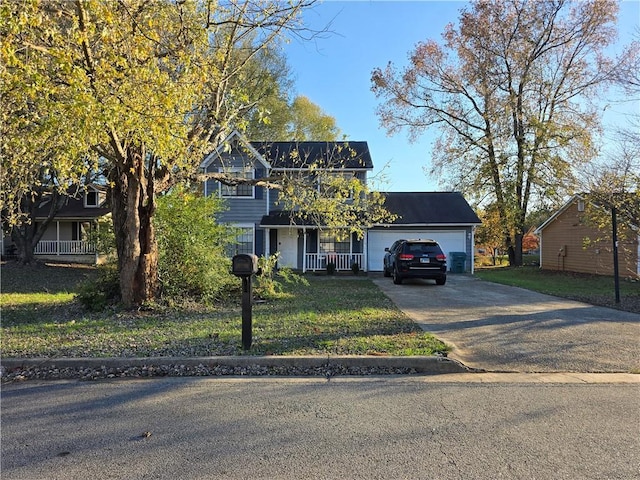 view of front of property with a front yard and a garage