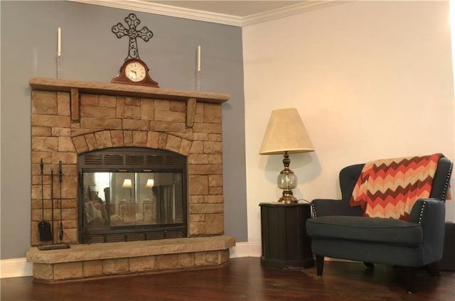 interior details with crown molding, baseboards, a glass covered fireplace, and wood finished floors