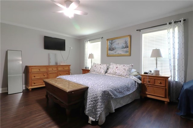 bedroom with crown molding, a ceiling fan, dark wood-style flooring, and baseboards