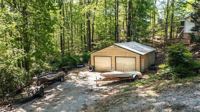 detached garage featuring a wooded view