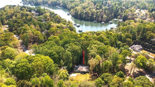aerial view with a water view and a wooded view