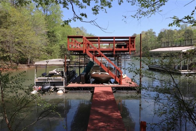 view of dock with a water view and a forest view