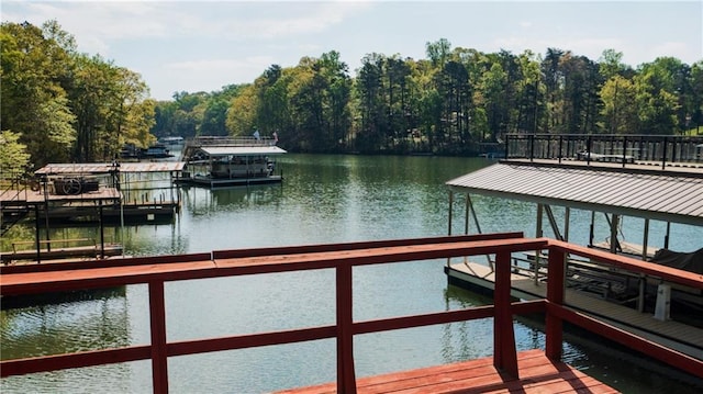 dock area with a water view and a wooded view