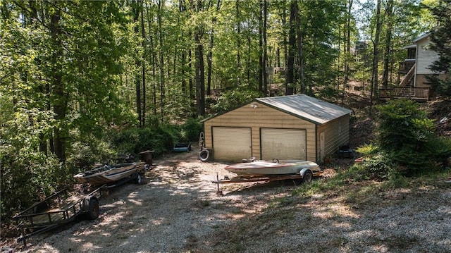 detached garage featuring a wooded view