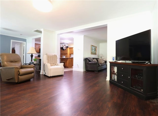 living area with crown molding, baseboards, and dark wood-type flooring