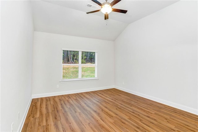 spare room with vaulted ceiling, ceiling fan, and light hardwood / wood-style floors