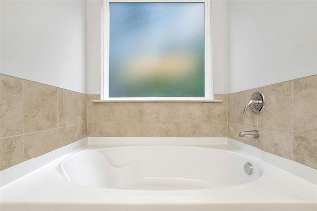 bathroom featuring a tub to relax in