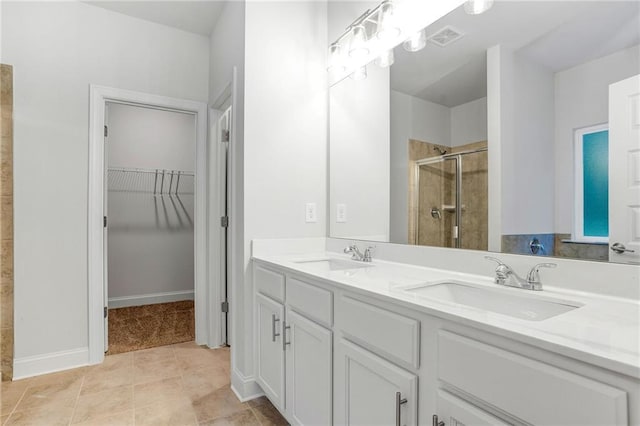 bathroom with tile patterned floors, vanity, and a shower with shower door