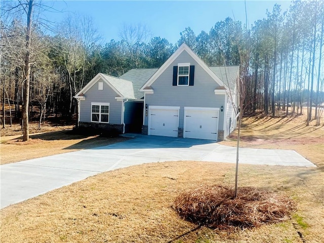 view of front of property featuring a garage and a front lawn