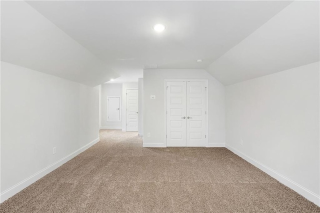 additional living space with lofted ceiling and carpet