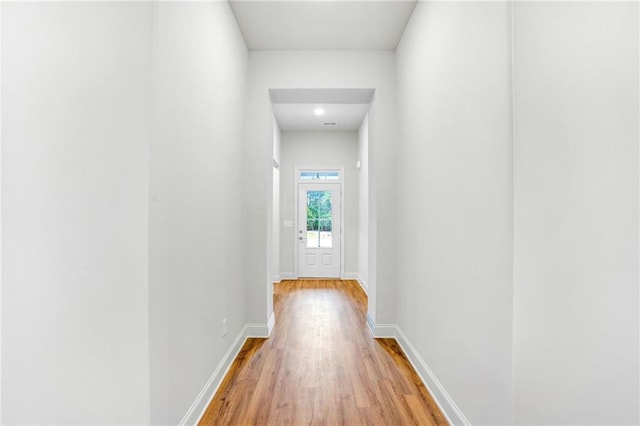 corridor with light hardwood / wood-style flooring