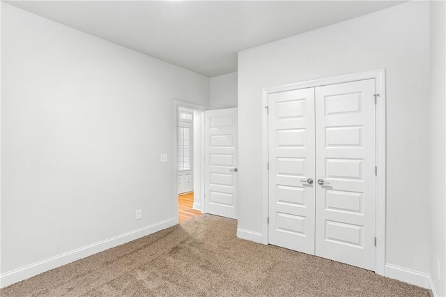 unfurnished bedroom featuring carpet and a closet