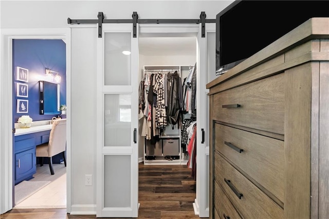 1208 Brandl Dr SW, Marietta, GA 30008 - spacious closet featuring a barn door, wood finished floors, and built in study area
