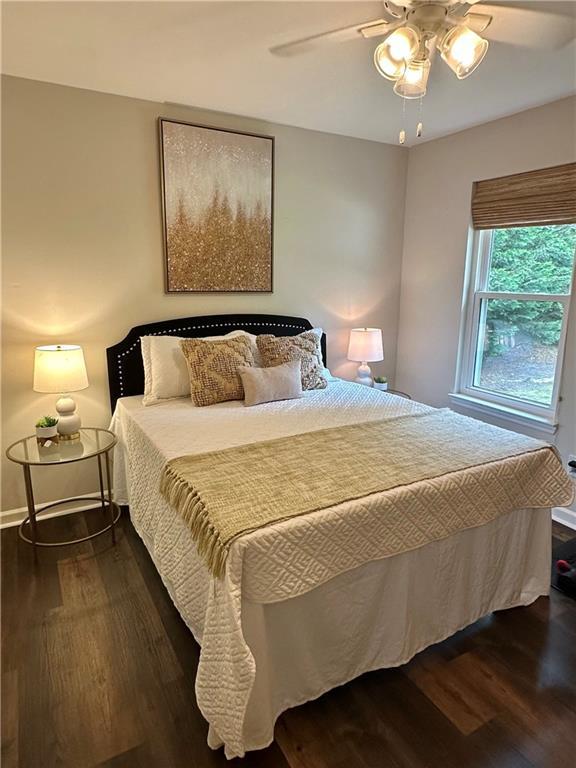 1208 Brandl Dr SW, Marietta, GA 30008 - bedroom featuring dark wood finished floors, a ceiling fan, and baseboards