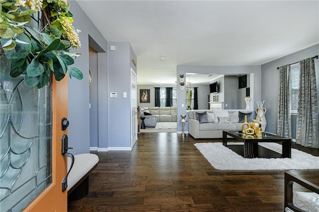 living room featuring dark wood finished floors and baseboards