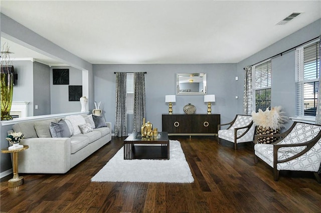 living room featuring visible vents and wood finished floors