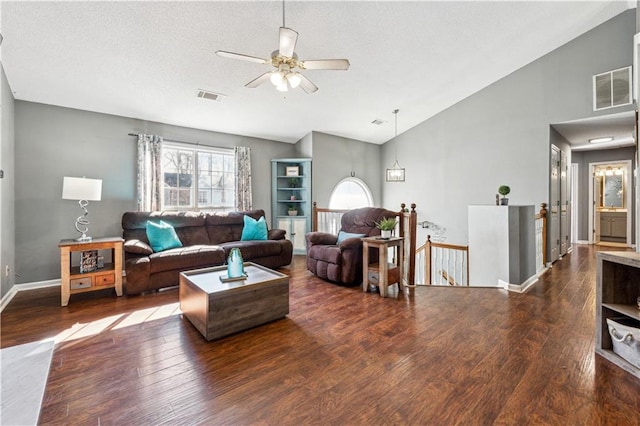 living room with ceiling fan, lofted ceiling, and dark hardwood / wood-style flooring