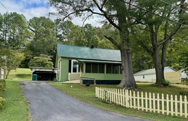 view of front of property with a front yard and a carport