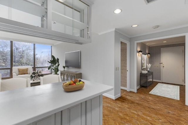 kitchen featuring ornamental molding and light parquet floors