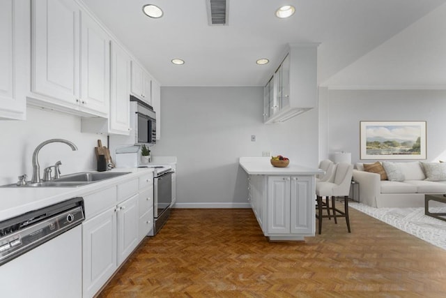 kitchen with appliances with stainless steel finishes, sink, light parquet floors, and white cabinets