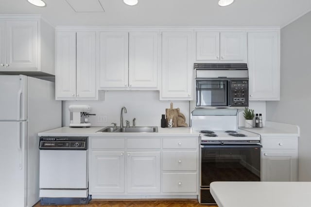 kitchen with white cabinetry, sink, and white appliances