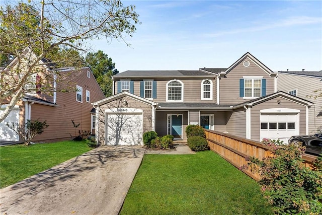 traditional-style home featuring driveway, a garage, fence, and a front lawn